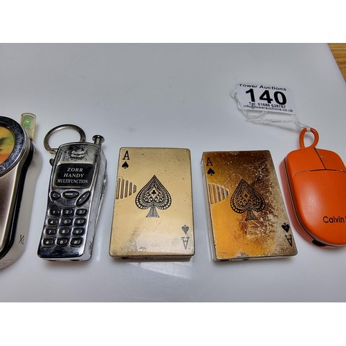 140 - A collection of 8x collectable novelty lighters to include 4x mobile phone formed lighters, 1 which ... 