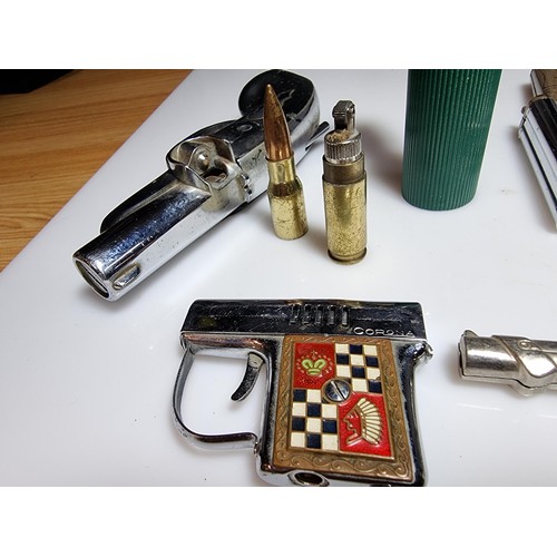 143 - A collection of 8 gun related collectable novelty lighters to include very rare Japanese collectable... 