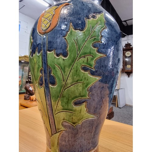 357 - A large antique impressive Belgian glazed vase featuring an incised art nouveau thistle design, made... 