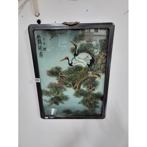 109 - A framed and glazed antique painting of 2 cranes in a tree, signed to the top left along with a doub... 