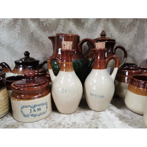 363 - Large quantity of stone ware salt glazed brown and tan jugs, storage jars, vinegar jugs, condiment s... 