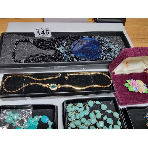 145 - A quantity of boxed costume jewellery to include turquoise style necklaces, a Royal Albert china flo... 