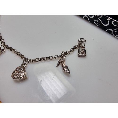 146 - A 925 silver charm bracelet with 7 charms all in set with crystal CZ stones, in clean condition, box... 