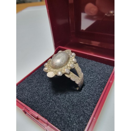 155 - A sterling silver hand crafted ring with an unusual design. In good clean condition, unmarked but te... 