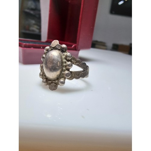 155 - A sterling silver hand crafted ring with an unusual design. In good clean condition, unmarked but te... 