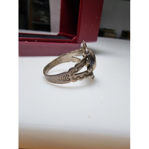 155 - A sterling silver hand crafted ring with an unusual design. In good clean condition, unmarked but te... 