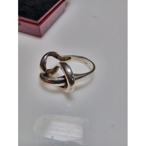 157 - An unusual chunky 925 silver ring with a fluent knot design, in good clean condition, boxed, size P,... 