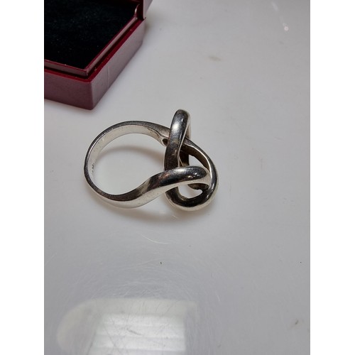 157 - An unusual chunky 925 silver ring with a fluent knot design, in good clean condition, boxed, size P,... 