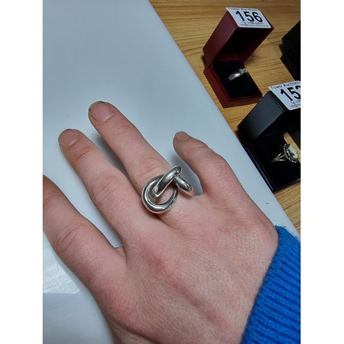 157 - An unusual chunky 925 silver ring with a fluent knot design, in good clean condition, boxed, size P,... 