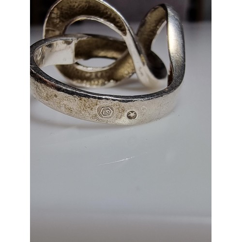 157 - An unusual chunky 925 silver ring with a fluent knot design, in good clean condition, boxed, size P,... 