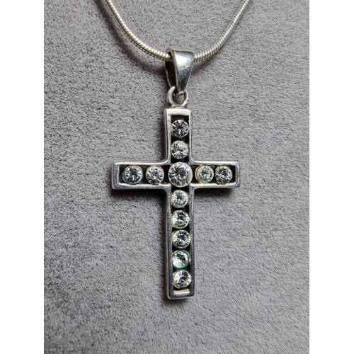 160 - A 925 silver cross pendant inset with CZ crystal stones on an 18