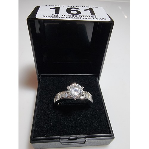 161 - An attractive chunky 925 silver dress ring with a large sparkly CZ crystal stone to the centre with ... 