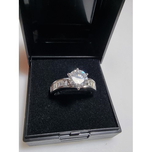 161 - An attractive chunky 925 silver dress ring with a large sparkly CZ crystal stone to the centre with ... 