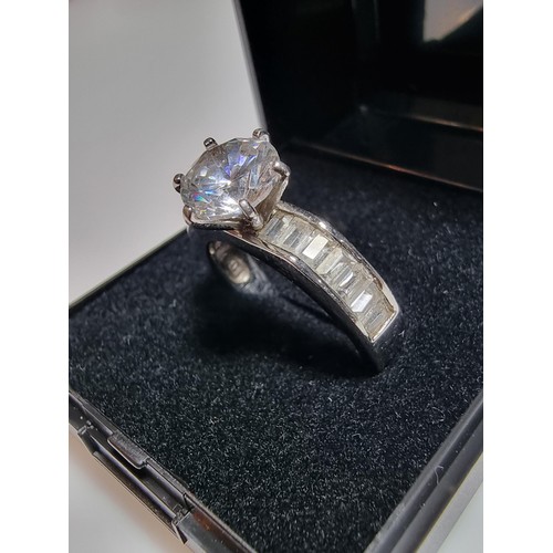 161 - An attractive chunky 925 silver dress ring with a large sparkly CZ crystal stone to the centre with ... 