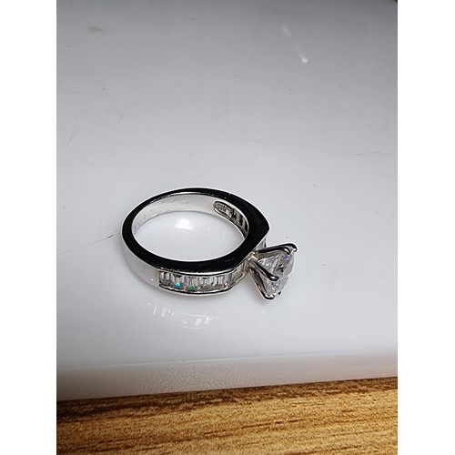 161 - An attractive chunky 925 silver dress ring with a large sparkly CZ crystal stone to the centre with ... 