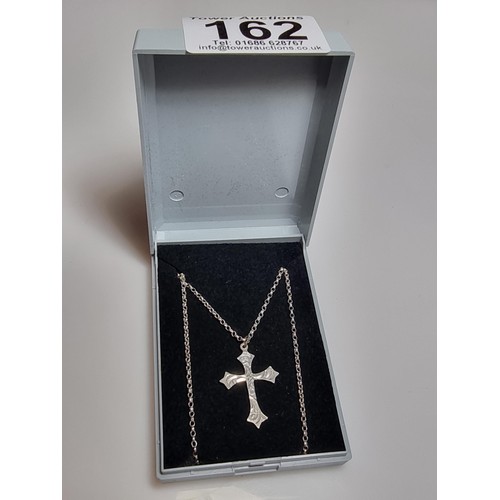 162 - A 925 silver engraved cross pendant set on a good 18