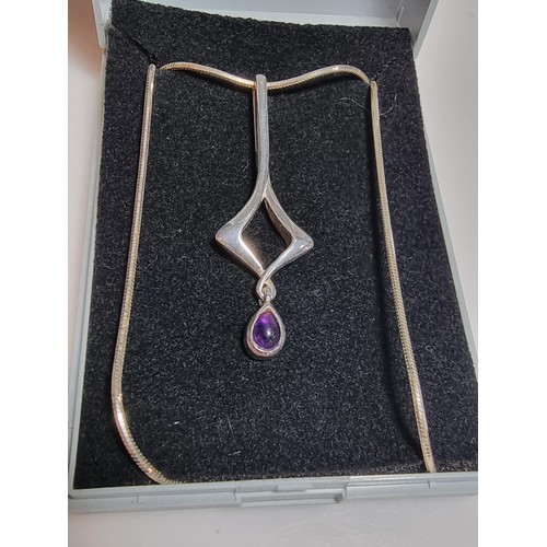 163 - An as new 925 silver drop pendant inset with an amethyst stone by Kit Heath set on an 18