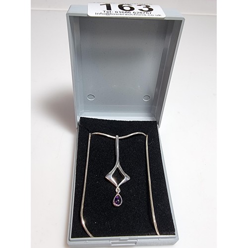 163 - An as new 925 silver drop pendant inset with an amethyst stone by Kit Heath set on an 18