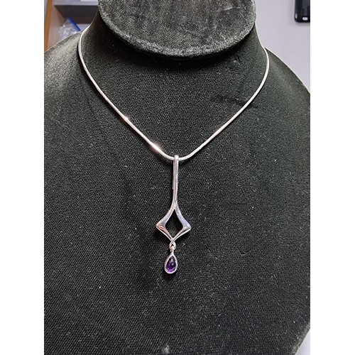 163 - An as new 925 silver drop pendant inset with an amethyst stone by Kit Heath set on an 18