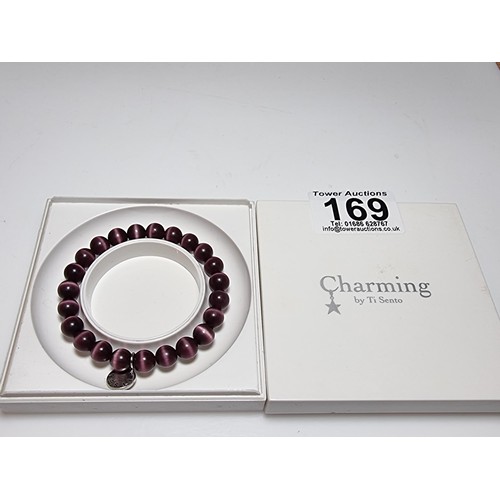 169 - An as new beryl cats eye stone bracelet charming by Ti sento with a 925 silver charm in good clean u... 