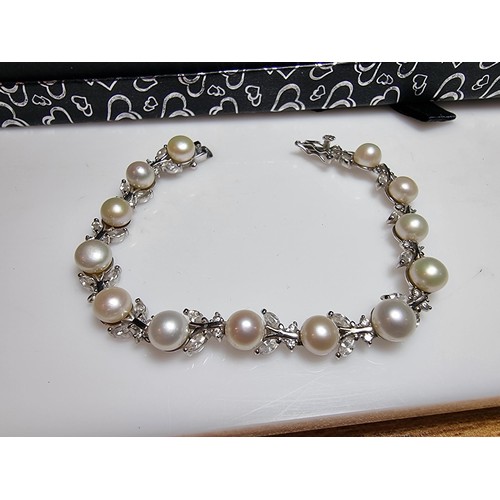 174 - A pretty as new 925 silver genuine pearl necklace inset with 13 pearls and a quantity of CZ crystal ... 