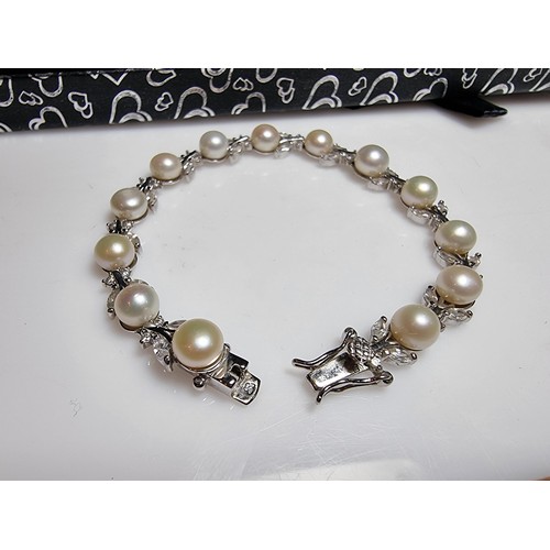 174 - A pretty as new 925 silver genuine pearl necklace inset with 13 pearls and a quantity of CZ crystal ... 