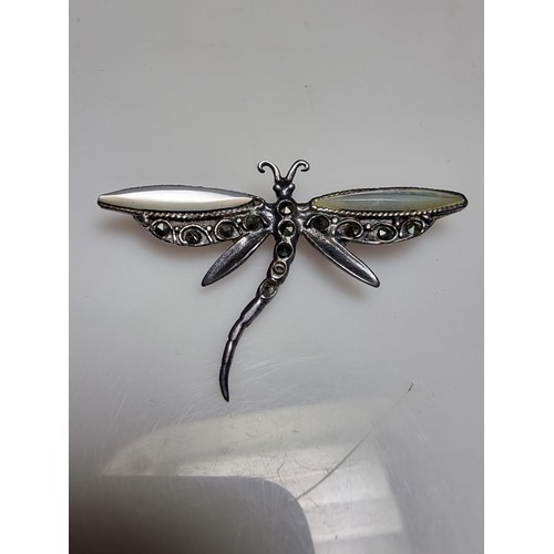 176 - A pretty 925 silver dragonfly brooch inset with mother of pearl on the wings and marcasite stones, i... 