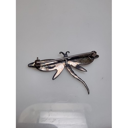 176 - A pretty 925 silver dragonfly brooch inset with mother of pearl on the wings and marcasite stones, i... 