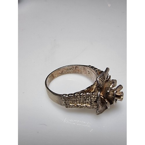 177 - A pretty 925 silver hand crafted rose ring with a shaped rose to the centre and a bark effect on the... 