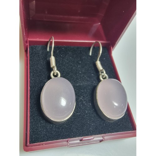 178 - A pair of pretty 925 silver drop earrings inset with large rose quartz cabochon stones. In good clea... 