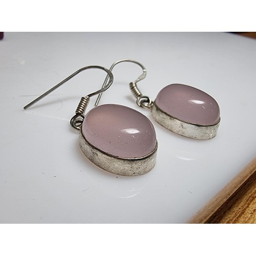 178 - A pair of pretty 925 silver drop earrings inset with large rose quartz cabochon stones. In good clea... 