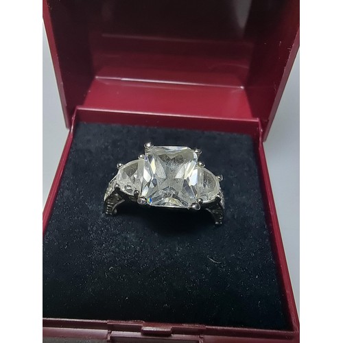 179 - A stunning 925 silver dress ring inset with 3 large crystal CZ stones and smaller crystal stones to ... 