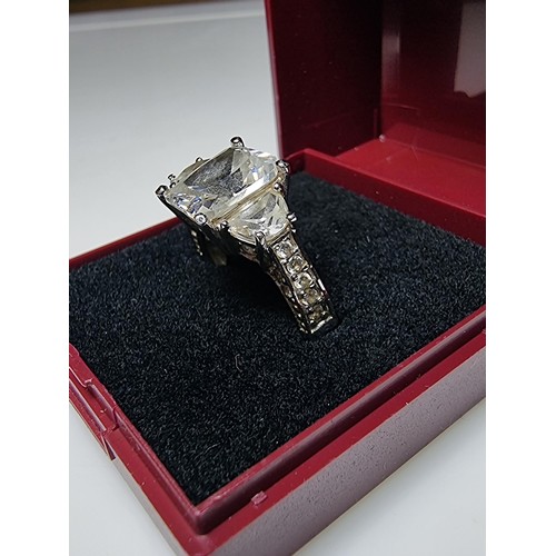 179 - A stunning 925 silver dress ring inset with 3 large crystal CZ stones and smaller crystal stones to ... 