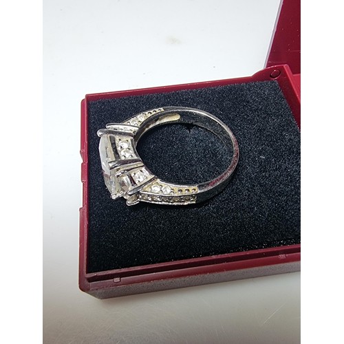 179 - A stunning 925 silver dress ring inset with 3 large crystal CZ stones and smaller crystal stones to ... 