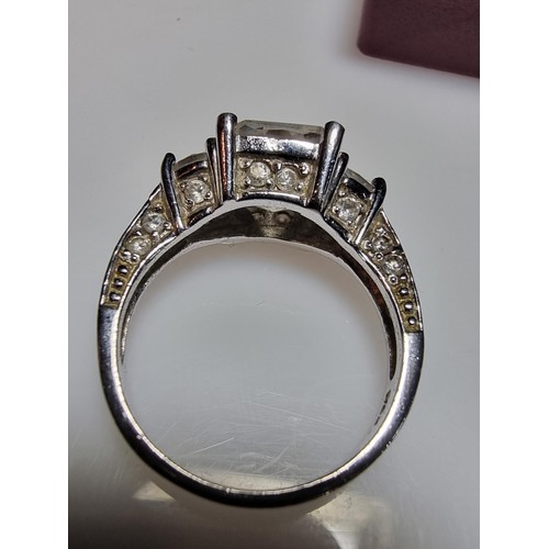 179 - A stunning 925 silver dress ring inset with 3 large crystal CZ stones and smaller crystal stones to ... 