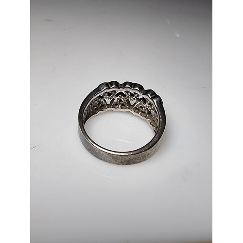 180 - A chunky 925 silver ring with a heart design inset with crystal CZ stones. In clean condition, boxed... 