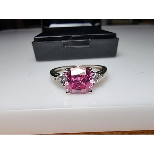 181 - A very pretty 925 silver dress ring inset with a large cushion cut pink crystal CZ stone with 2 clea... 