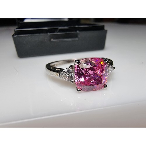 181 - A very pretty 925 silver dress ring inset with a large cushion cut pink crystal CZ stone with 2 clea... 