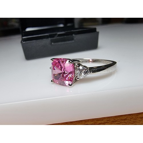 181 - A very pretty 925 silver dress ring inset with a large cushion cut pink crystal CZ stone with 2 clea... 