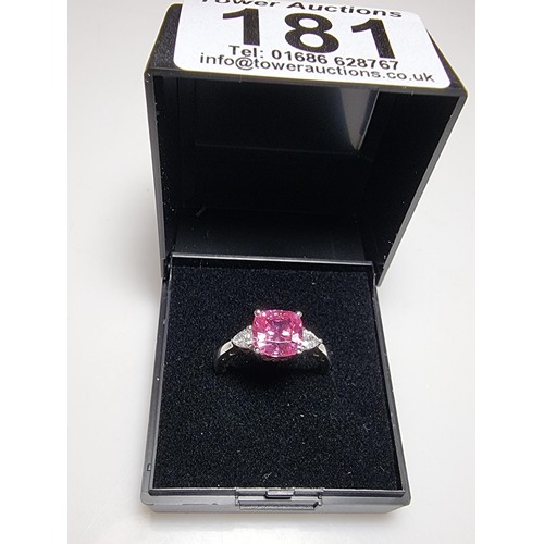 181 - A very pretty 925 silver dress ring inset with a large cushion cut pink crystal CZ stone with 2 clea... 