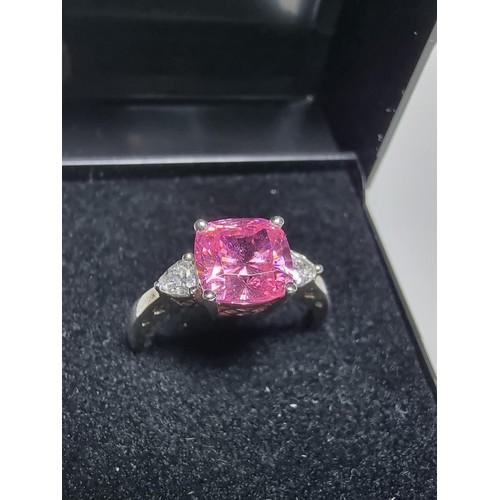 181 - A very pretty 925 silver dress ring inset with a large cushion cut pink crystal CZ stone with 2 clea... 