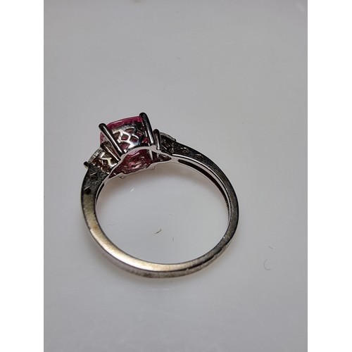 181 - A very pretty 925 silver dress ring inset with a large cushion cut pink crystal CZ stone with 2 clea... 