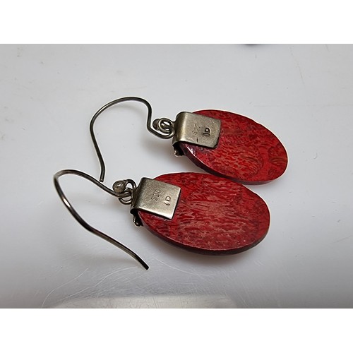 182 - A pair of pretty 925 silver and red stained wood earrings with an ornate design. In good clean condi... 