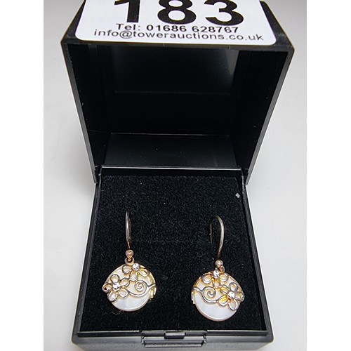 183 - A pair of pretty 925 silver drop earrings inset with mother of pearl having a floral design inset wi... 