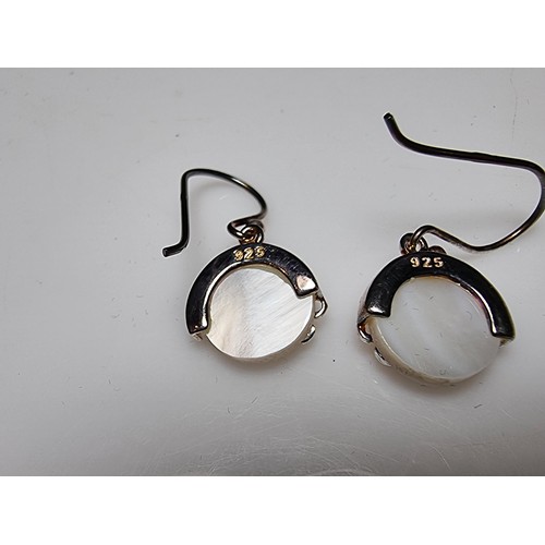 183 - A pair of pretty 925 silver drop earrings inset with mother of pearl having a floral design inset wi... 