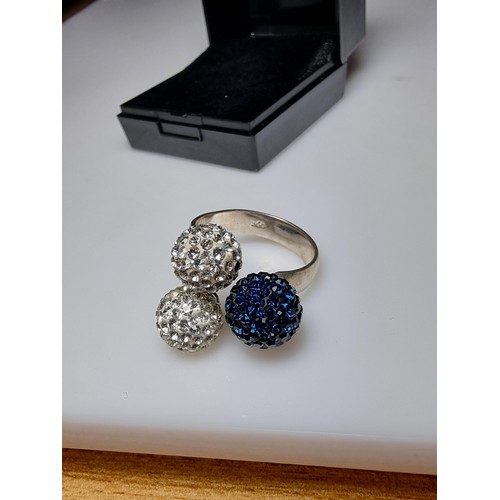 184 - A 925 silver unusual ring with 3 large balls in set with clear studded crystals and blue studded cry... 