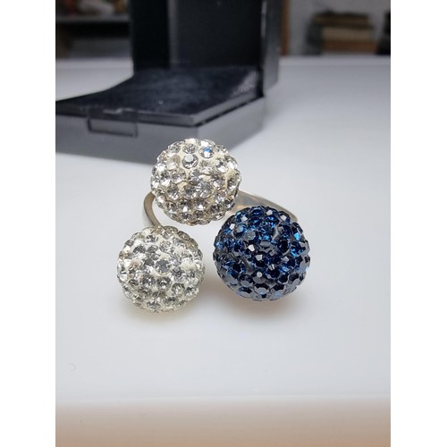 184 - A 925 silver unusual ring with 3 large balls in set with clear studded crystals and blue studded cry... 