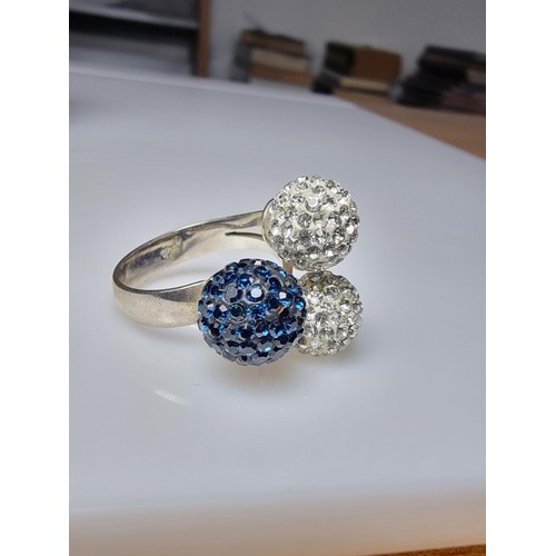 184 - A 925 silver unusual ring with 3 large balls in set with clear studded crystals and blue studded cry... 