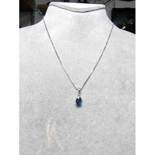 190 - A pretty 925 silver pendant inset with a genuine blue sapphire stone on an 18