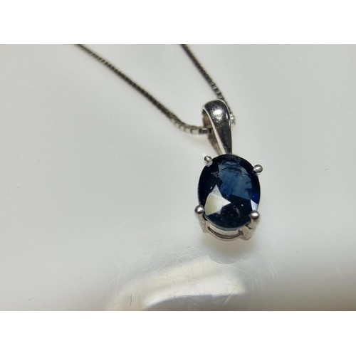 190 - A pretty 925 silver pendant inset with a genuine blue sapphire stone on an 18